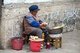 China: Elderly Naxi woman, Lijiang Old Town, Yunnan Province